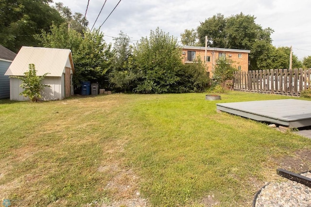 view of yard featuring a storage unit and a deck