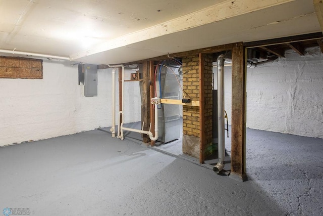 basement with electric panel and heating unit