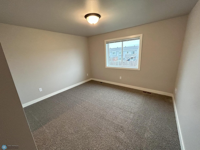 unfurnished room featuring carpet