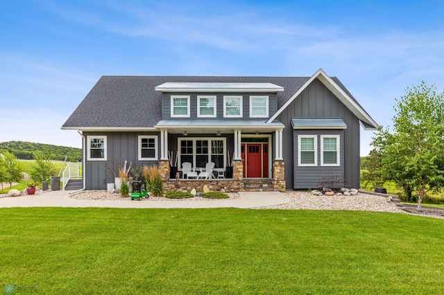 view of front of house with a porch and a front lawn