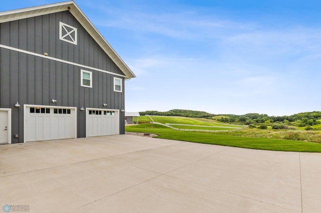 view of home's exterior with a lawn and a garage