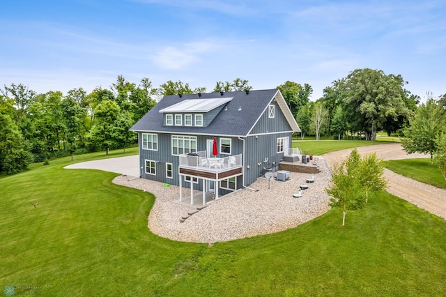 rear view of property featuring a lawn