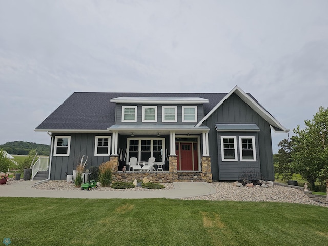 view of front of property with a porch and a front yard