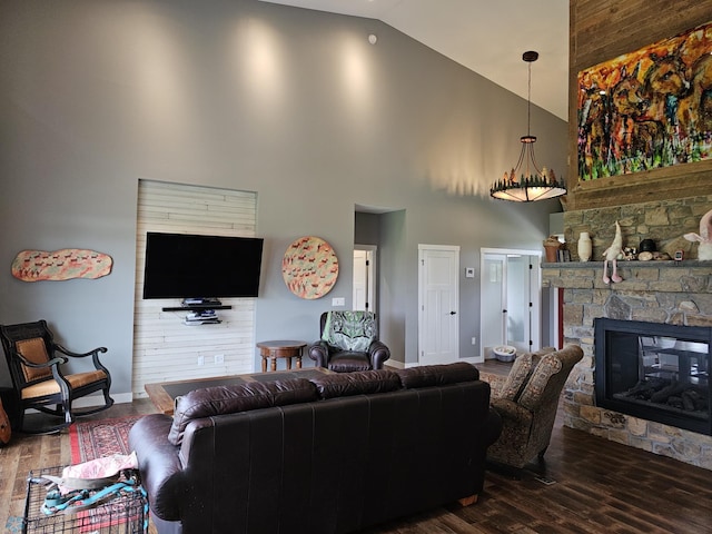 living room featuring a stone fireplace, high vaulted ceiling, and dark hardwood / wood-style flooring