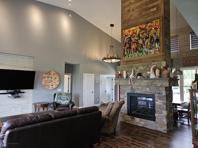 living room with dark wood-type flooring, a stone fireplace, and high vaulted ceiling