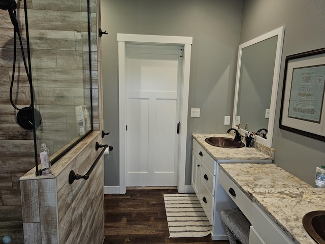 bathroom with vanity, a shower, and hardwood / wood-style flooring