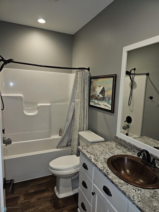 full bathroom featuring shower / bath combo with shower curtain, toilet, hardwood / wood-style flooring, and vanity