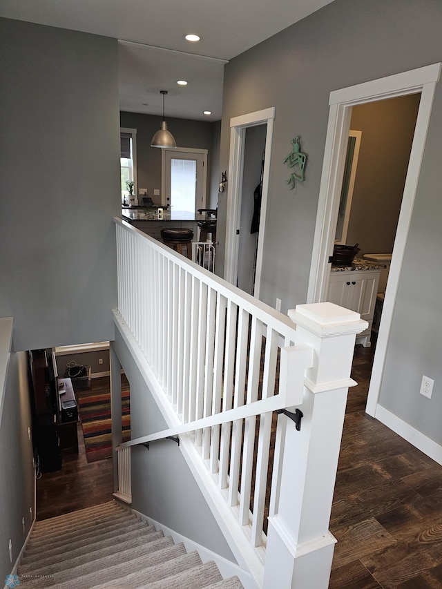 stairway with hardwood / wood-style flooring