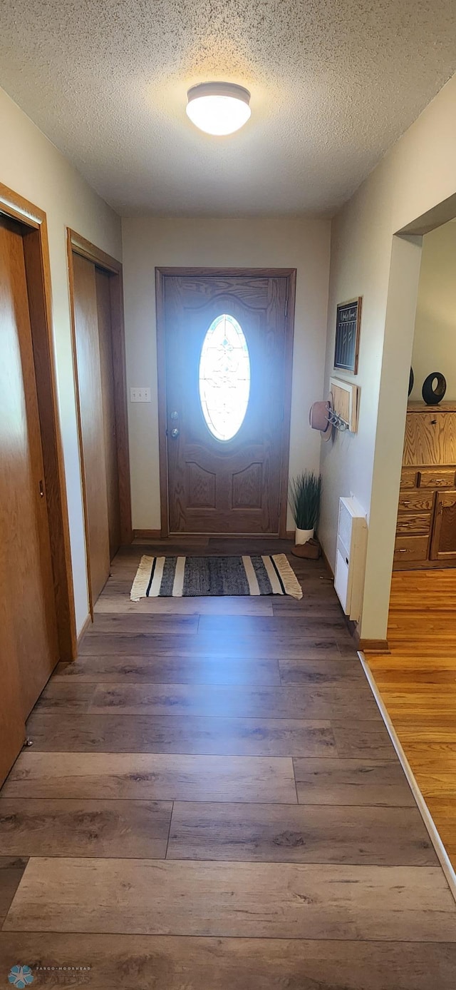 entryway featuring hardwood / wood-style flooring and a textured ceiling