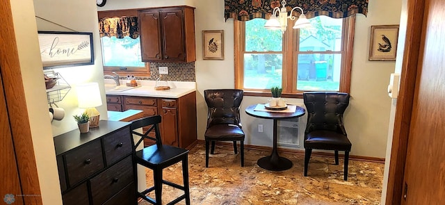 kitchen featuring tasteful backsplash, plenty of natural light, and sink