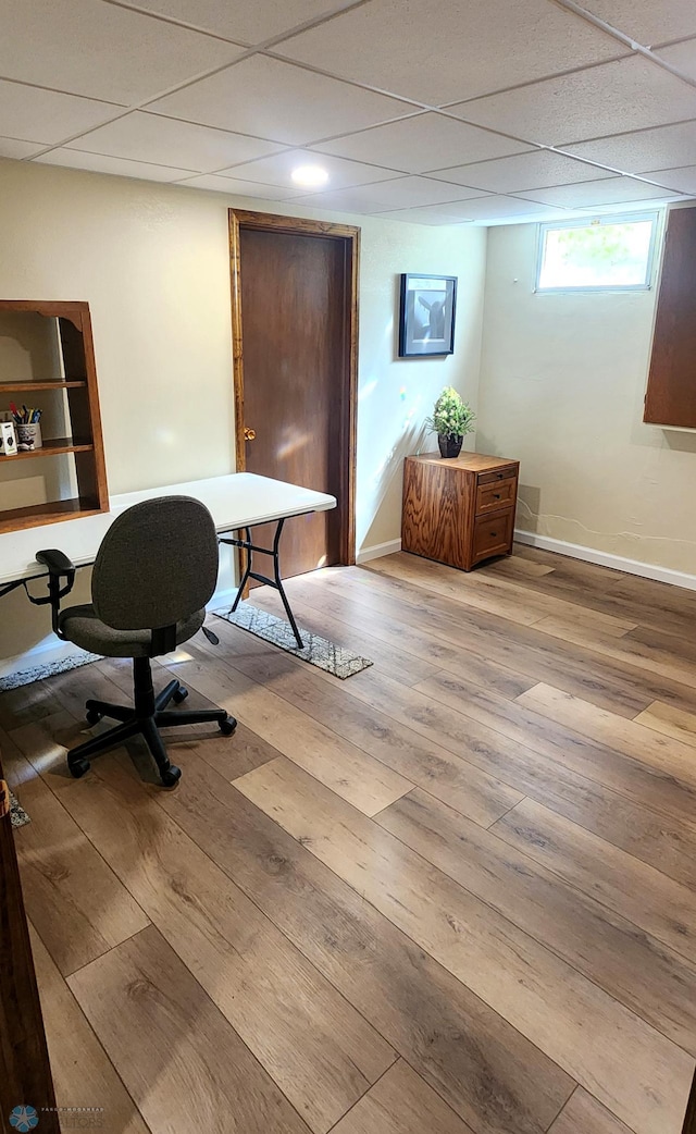 home office featuring hardwood / wood-style floors and a drop ceiling