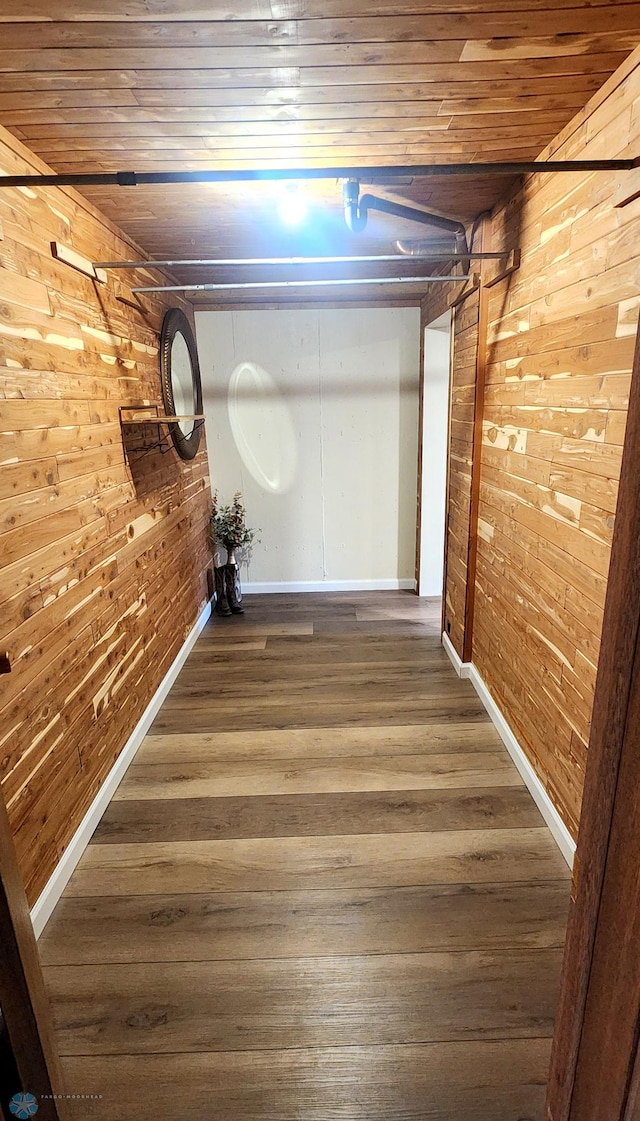 corridor with wood ceiling, hardwood / wood-style floors, and wooden walls