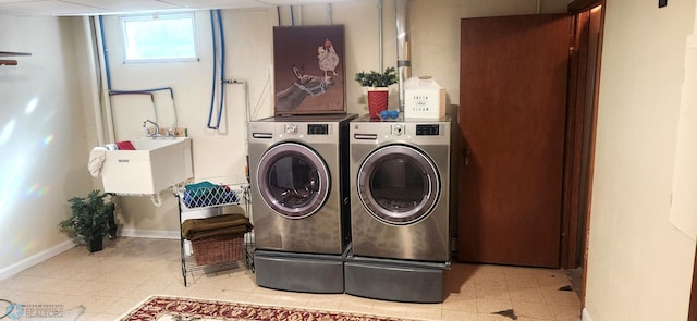 clothes washing area featuring washing machine and dryer and sink