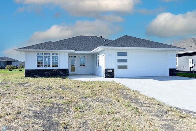 ranch-style home featuring a garage and a front yard