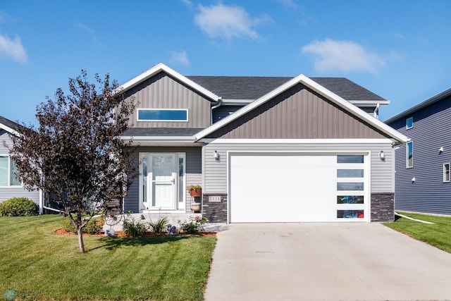 craftsman house with a front lawn and a garage