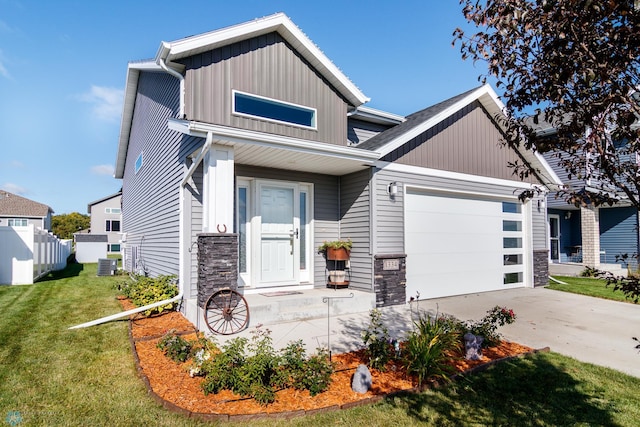 craftsman-style house featuring cooling unit, a garage, and a front yard