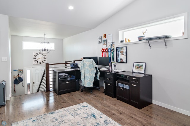 office area with an inviting chandelier, lofted ceiling, and dark hardwood / wood-style floors