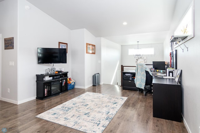 office area with a notable chandelier and dark hardwood / wood-style floors