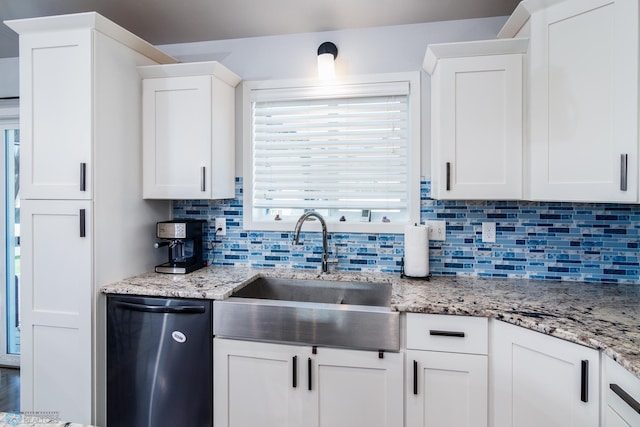 kitchen featuring white cabinets, sink, tasteful backsplash, and stainless steel dishwasher