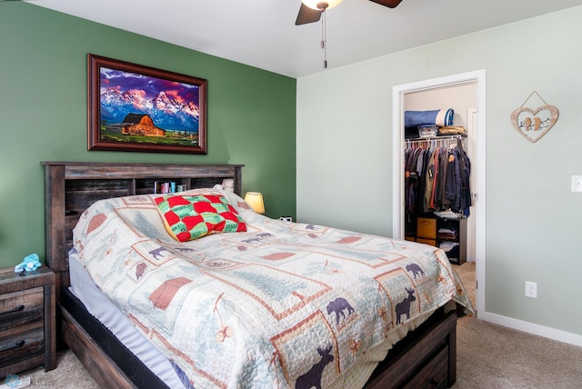 carpeted bedroom featuring a closet, a walk in closet, and ceiling fan