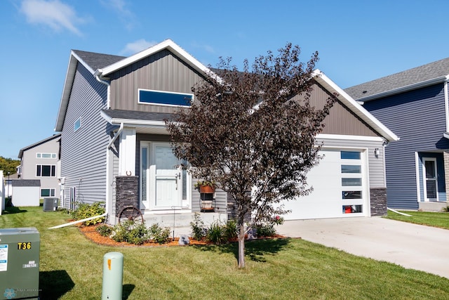 craftsman-style home with a front yard, central air condition unit, and a garage