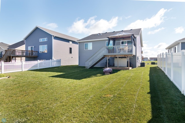 back of property with central AC, a gazebo, a deck, and a yard