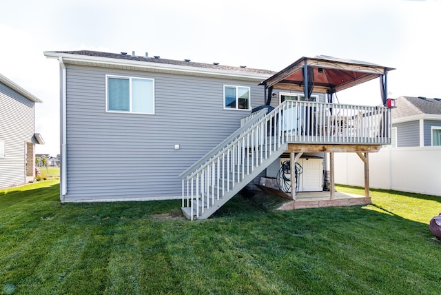 back of house with a gazebo, a deck, and a yard