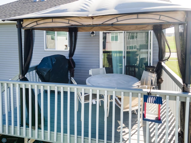 exterior space featuring a deck and a gazebo