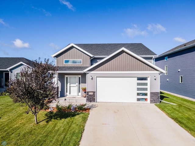 craftsman house featuring a front yard and a garage