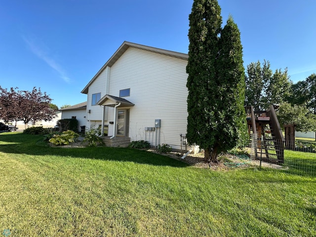 view of side of home with a lawn