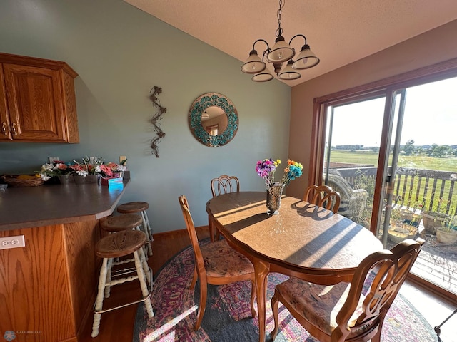 dining space with a chandelier and hardwood / wood-style floors