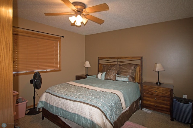 bedroom featuring a textured ceiling, ceiling fan, and carpet