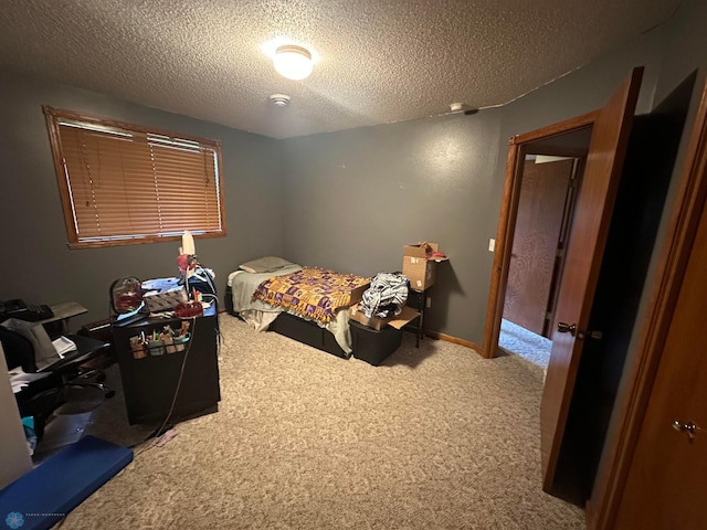 carpeted bedroom with a textured ceiling