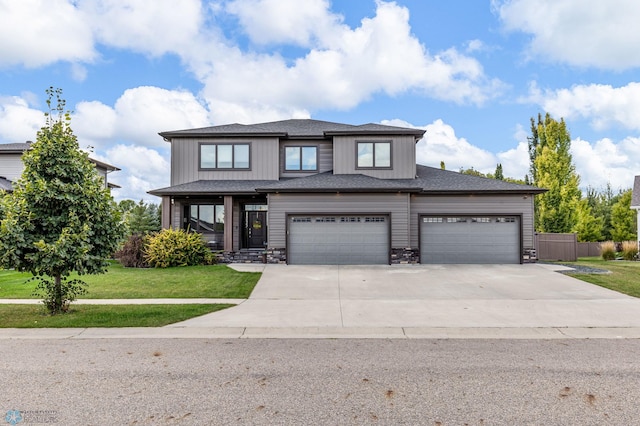 view of front of property featuring a garage and a front lawn