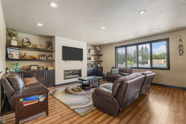 living room featuring a textured ceiling and hardwood / wood-style flooring