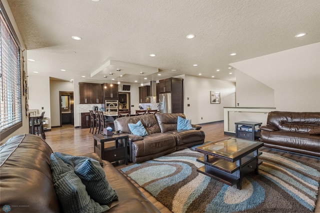 living room with hardwood / wood-style flooring and a textured ceiling