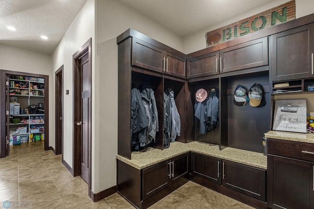 mudroom featuring a textured ceiling