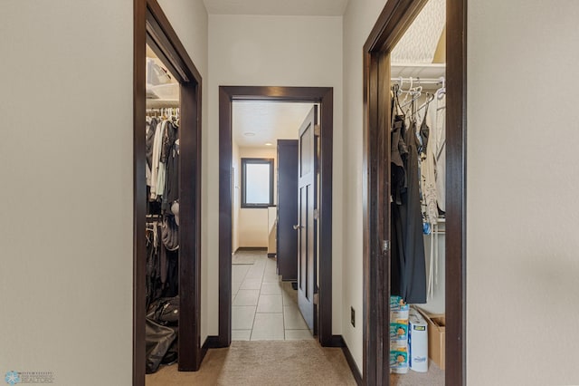 corridor featuring light tile patterned floors