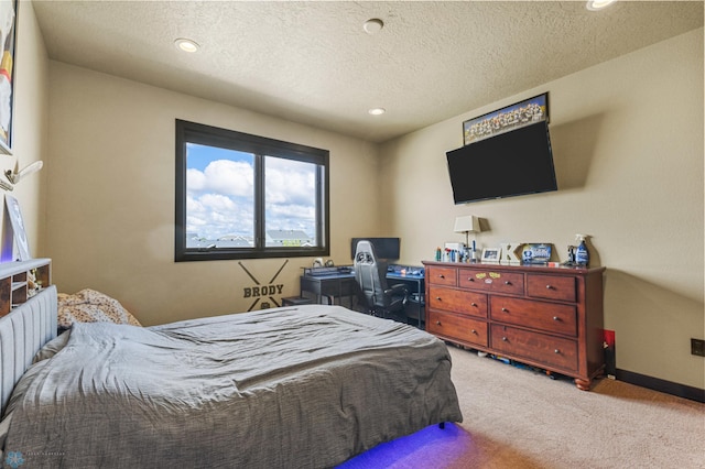 bedroom with carpet and a textured ceiling