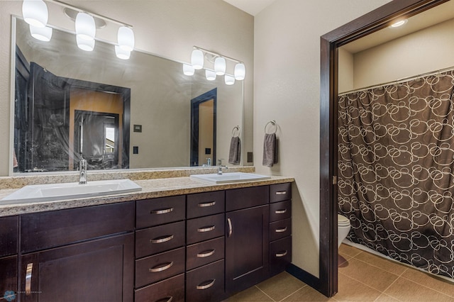 bathroom featuring vanity, toilet, a shower with curtain, and tile patterned floors