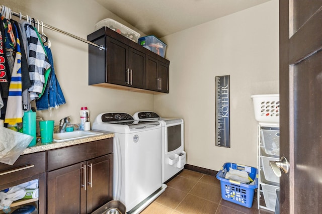 laundry room with cabinets, independent washer and dryer, and sink