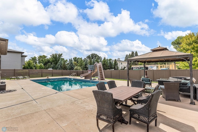 view of swimming pool featuring a water slide, a patio area, and a gazebo