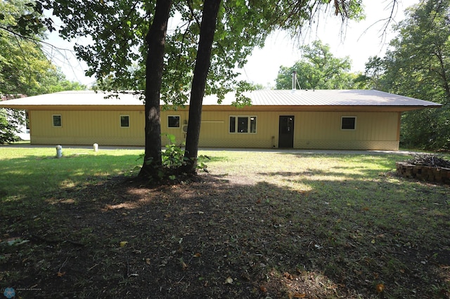 back of property featuring a yard