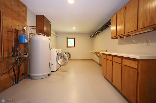 clothes washing area featuring washing machine and clothes dryer and electric water heater