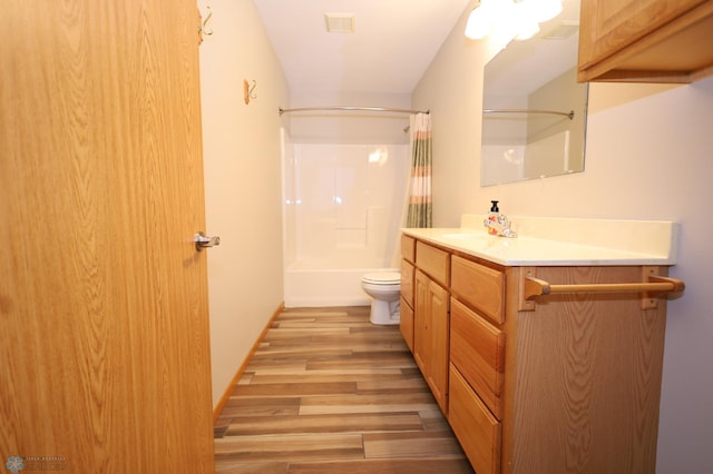 full bathroom with shower / bath combination with curtain, wood-type flooring, toilet, and vanity