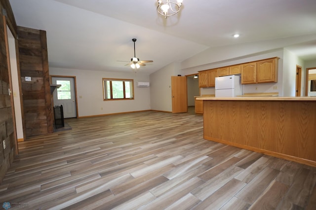 kitchen featuring ceiling fan, white refrigerator, vaulted ceiling, and light hardwood / wood-style floors