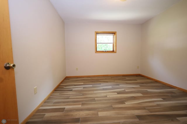 unfurnished room with light hardwood / wood-style floors