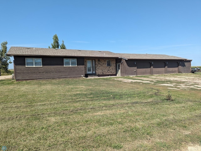 view of front of home with a garage and a front lawn