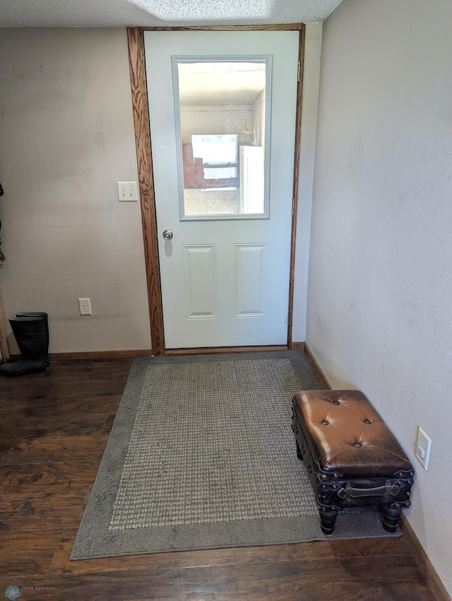 doorway to outside with a textured ceiling and hardwood / wood-style floors