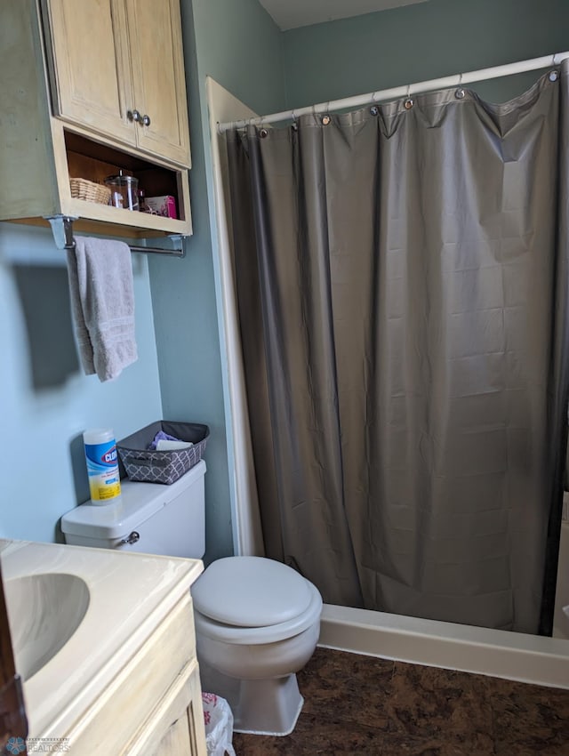 bathroom featuring vanity, toilet, and a shower with shower curtain